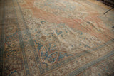 Antique Jalili Tabriz carpet with distressed pile, showing apricot and sky blue floral motifs.