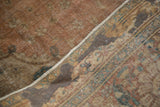 Antique Jalili Tabriz carpet reverse, revealing foundation weave and old adhesive remnants.