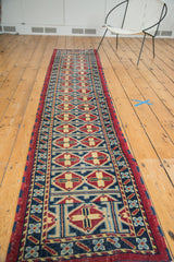 Geometric motif and rich cherry red border of the hand-knotted vintage Afghani runner.