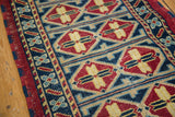 Double column repeating medallion motif in cherry red, indigo, sky blue, saffron, and ivory hues.
