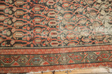 Distressed vintage Malayer rug runner, red paisley boteh, dark navy, tattered fringe.