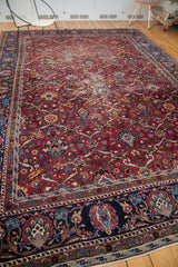 Vintage Yezd rug's dark blue border, showing elaborate palmette and ribbon leaf motifs.