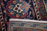 Intricate pattern and fringe of the vintage Persian Yezd carpet, with visible hand-knotted foundation.
