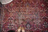 Vintage Yezd carpet with distressed texture, showing elaborate palmette motifs on red.