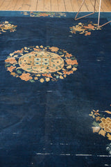Traditional Peking carpet's cobalt blue field with terra cotta and pistachio floral branches.