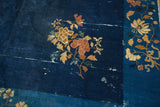 Detail of cobalt and sky blue Peking carpet featuring gold and terra cotta chrysanthemum flowers.