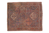 Vintage Qashqai rug, repeating geometric panels, stylized animals and plants in madder red, sky blue, beige.