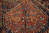 Qashqai rug showcasing germinating plant motif, geometric panel, madder red, and sky blue.