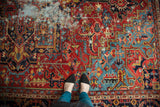 Vivid ruby red, pale sapphire blue geometric antique Heriz carpet with isolated distress.