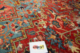 Visible worn foundation with ruby red and sapphire geometric motifs on an antique Heriz rug.