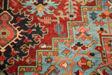 Antique Heriz rug detail: ruby red and pale sapphire blue geometric patterns, visible knot heads.