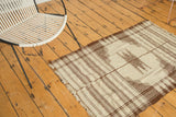 Primitive ivory and chocolate striped bands with zigzag motif and frayed fringe.