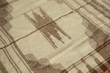 Zigzag and finned comb motifs in chocolate brown on ivory background of the Kurdish rug.