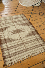 Vintage Kurdish rug corner with ivory and chocolate brown striped pattern, light tattered fringe.