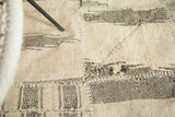 Ivory and brown-black diamond panels joined by white blanket stitch in Kurdish patchwork.