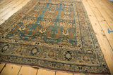 Intricate curvilinear serrated leaves in faded tangerine on sky blue antique Jalili Tabriz rug.