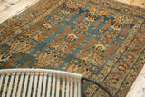 Expressive curvilinear serrated leaf motifs in sky blue, faded orange on this antique Jalili Tabriz rug.