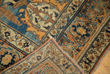 Curvilinear serrated leaf patterns and fringe detail on this antique Jalili Tabriz rug corner.