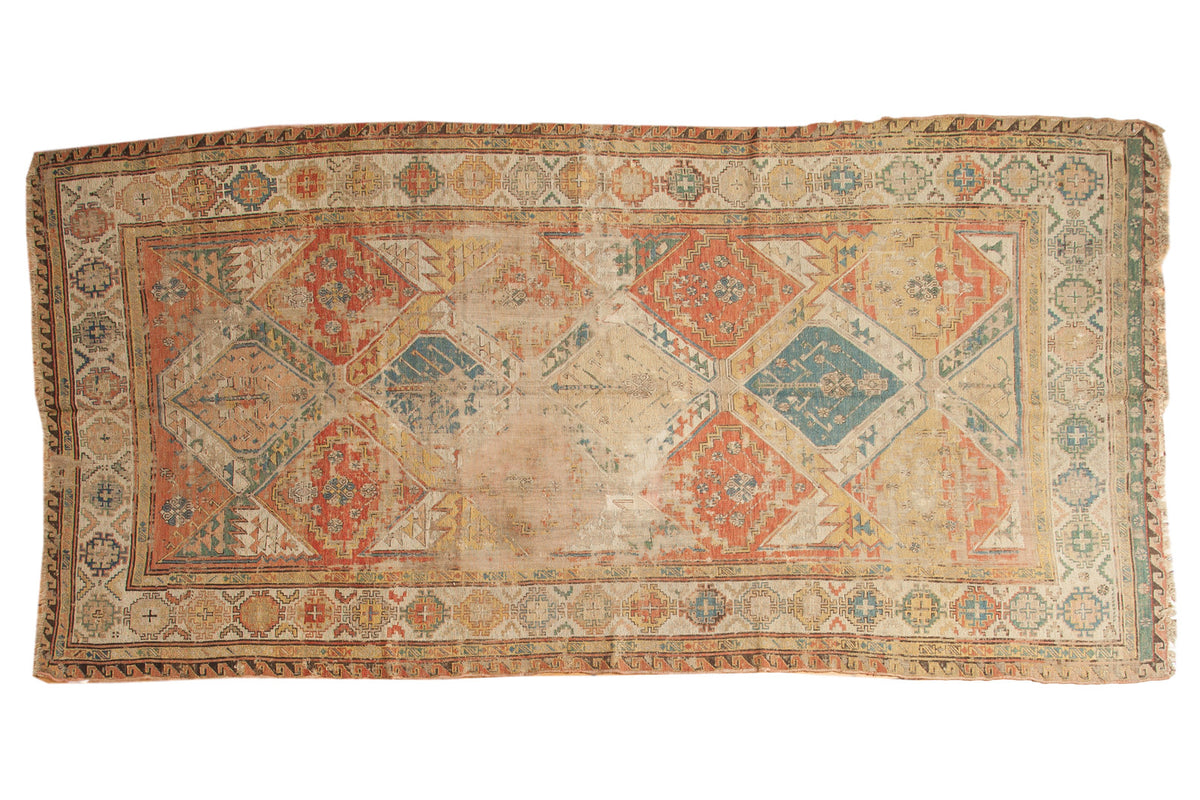 Antique Soumac carpet, faded geometric lattice in terra cotta, blue, and ivory. 5'6" x 10'6".