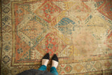 Antique Soumac carpet's multi-paneled lattice with alternating rust, gold, blue, green colors, and wear.