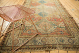 Antique Soumac carpet corner: geometric borders, lattice motifs, and natural fringe.