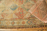 Antique Soumac carpet section showcasing multi-paneled lattice in terra cotta, gold, and blue.
