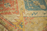 Antique Soumac flatweave detail: geometric patterns in rust, gold, blue, and ivory.