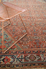 Detail of vintage Mission Malayer rug: aqua border, floral cross-sections, serrated leaves.