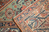 Fringed corner detail of vintage Mission Malayer rug with serrated leaf and floral motifs.