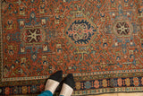 Vintage Karaja rug with madder root red geometric field and dark blue stylized floral border.