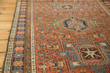 Karaja rug detail: madder red field with geometric floral cross sections and sky blue motifs.