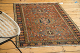 Vintage Karaja rug detail: madder root red field, dark blue floral border, and fringe.