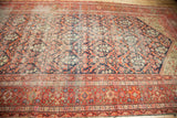 Antique Persian Malayer gallery runner showcasing intricate border and allover patterns in muted red and navy.