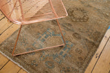Distressed vintage Karaja runner displaying geometric sky blue patterns on a beige field.