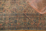 Traditional Lavar Kerman rug detail, intricate Shah Abbas floral motifs in softened ivory, blush, and blue.