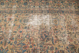 Close-up of vintage Lavar Kerman rug, showing professionally restrung foundation amidst intricate floral design.