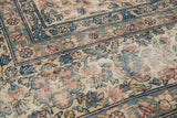 Shah Abbas inspired Kerman border detail with intricate blue, blush, and ivory florals.