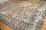 Vintage Lavar Kerman carpet corner, displaying textured floral palmettes in ivory, blush, and sky blue.