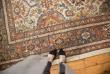 Vintage Mahal carpet's rich rust, ivory, blue, and saffron border patterns with knot head wear.