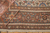 Detailed rust, ivory, and charcoal floral border of a hand-knotted Persian Mahal rug.