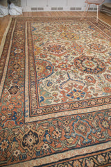 Vintage Mahal carpet corner with rust, ivory, blue lattice pattern and detailed borders.