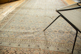 Visible foundation texture of distressed Khotan runner, floral lattice in faded teal.