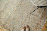 Antique Khotan runner's distressed floral lattice pattern in teal, apricot, and ivory tones.