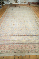 Distressed antique Khotan runner showing faded blue floral trellis and apricot patterned border.