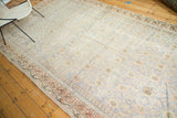 Faded geometric border and distressed floral field of an antique Samarkand Khotan rug.