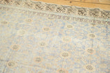 Antique Khotan rug: distressed pile showing foundation, faded blue, apricot, ivory tones.