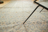 Textured Khotan runner featuring distressed teal blue, apricot, and ivory floral lattice motif.