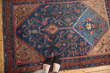 Hand-knotted vintage rug featuring an unusual asymmetric vase planter, Herati design, and blues.