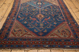 Corner of a Vintage Kurdish Hamadan rug, revealing geometric borders and Herati design field with fringe.