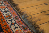 Secure side and chocolate brown fringe of the vintage South West Persian rug with geometric patterns.